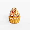 Freshly Baked Cupcake With Swirled Cream Frosting And Caramel Drizzle