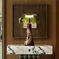 Elegant Red Table Lamp With Golden Patterns And Green Petal Shade On Marble Countertop