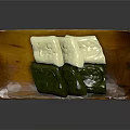 Traditional Green And White Dessert Pastries Arranged On Wooden Serving Plate