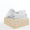 Woven Storage Basket with Rolled Light Gray Towels for Bathroom Organization