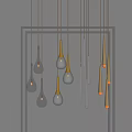 Multiple Illuminated Pendant Lights With Glass Teardrop And Metal Cylindrical Designs Hanging On Dark Background