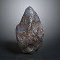 Irregular Shaped Textured Stone With Metallic Blue And Brown Hues On Gray Gradient Background