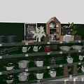 Cookware Display Shelf With Pots Pans Kettles Chalkboard And Green Plant