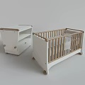 Modern White Baby Crib With Wooden Railings And Matching Drawer Cabinet