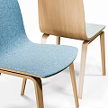 Modern Round Wooden Table With White Legs And Four Colored Upholstered Chairs
