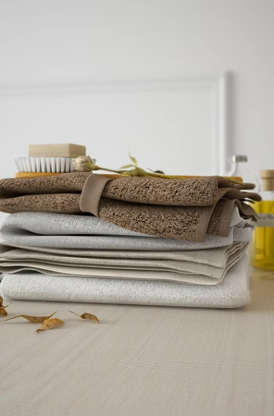 Soft Stacked Towels In Neutral Tones With Bathroom Accessories And Leaves 3d model