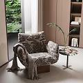 Patterned Accent Chair with Knitted Blanket Potted Plant on Side Table and Garden View Window