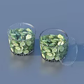 Fresh Cucumber Slices Stored in Transparent Glass Jars With One Lid Open