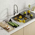 Modern Kitchen Faucet Over Stainless Steel Sink With Fresh Lemons And Cucumbers