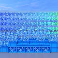 Outdoor Colorful Windmill Art Installation With Blue Green Blades And Blue Base Structure