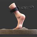 Man's Foot Model With Ankle Chain Displayed On Round Stone Base