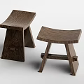 Two Simple Wooden Stools With Curved Seat And Crossed Legs Design