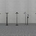 Modern Floor Lamps With Various Designs Metal Stands And Illuminated Shades Against Minimalist Wall