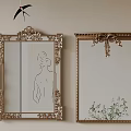 Two Gold Framed Mirrors On Beige Wall With Ornate Details Featuring Female Silhouette And Plant