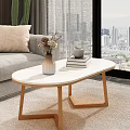 Oval White Coffee Table with Vase Dried Flowers Small Teacup Books and Wooden Legs