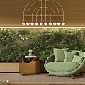 Green Single Seater Sofa With Soft Cushions By Lush Plant Wall And Gold Side Table