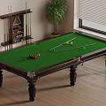 Billiard Table With Green Felt Surface Balls Cues And Potted Plant In Room