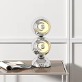 Modern Double Transparent Sphere Table Lamp Illuminated on Wooden Table with Magazine