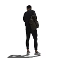 A man with backpack wearing black jacket and pants checking watch in white shoes