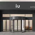 Modern Hotel Entrance With Revolving Glass Door And Black Facade IU Signage