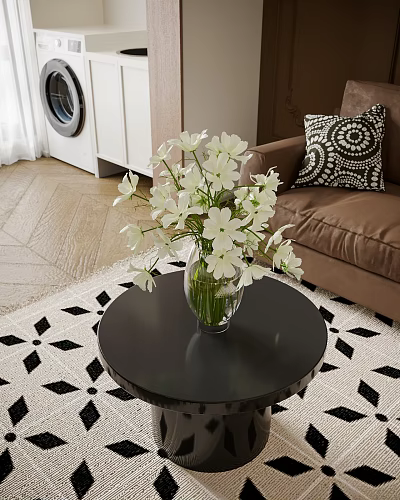 White Flowers in Glass Vase on Black Round Coffee Table with Brown Sofa and Geometric Rug 3d model