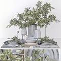 Stylish Tableware Set with Green Plants Wine Glasses Plates and Candle Holders on White Table