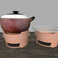 Traditional Clay Cooking Pot With Lid And Stand Alongside Mesh Covered Heating Tool