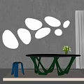 Multiple Irregular Shaped Mirrors On Gray Wall With Black Table Green Legs Blue Stool And Flowers