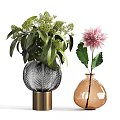 Textured Glass Vase With Gold Base And Green Foliage Alongside Amber Vase Holding Pink Dahlia