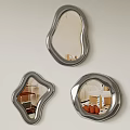Three Irregular Shaped Silver Framed Mirrors Hanging On Light Wall Reflecting Room Details