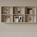 Modern White Wall Mounted Bookshelf With Compartments And Books On Light Colored Wall