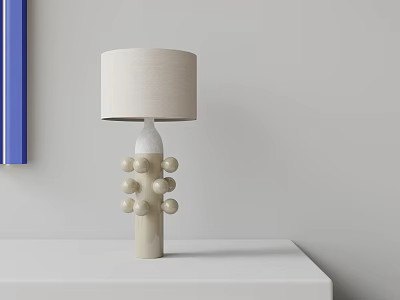 Beige Linen Shade Table Lamp With White Ceramic Base Round Decorative Balls On White Tabletop 3d model