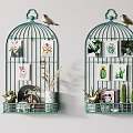 Green Birdcage Wall Decor With Decorative Prints Small Plants And Bird Figurines On White Wall