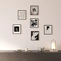 Wall Decor With Framed Artworks And Tabletop Items Lamp Books Candle And Decorative Bowl
