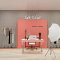 Modern Public Office Area With Pink Backdrop Hanging Fashion Clothes Laptop Table And White Chair