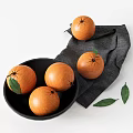 Fresh Ripe Oranges in Black Bowl with Gray Cloth and Green Leaves