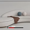 White Curved Sectional Sofa With Blue Beige Cushions And Brown Throw Blanket