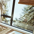 Natural Style Double Bed With Macramé Wall Hanging Palm Plants Bamboo Blinds And Woven Rug