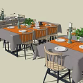Dining Table Set Featuring Gray Orange Tablecloths Wooden Chairs Tableware And Potted Plants