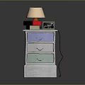 Colorful Drawer Nightstand With Table Lamp Stack Of Books And Alarm Clock