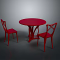 Red Round Dining Table With Two Red Chairs In Dark Background