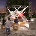 Outdoor Stage Scene With Bright Lights People On Wooden Crate Seats And City Night View