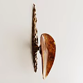 Abstract Wall Lamp With Unique Brown Amber Shade And Metallic Frame On White Wall