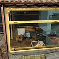 Elevated Metal Shack With Corrugated Roof Satellite Dish Speakers And Balcony