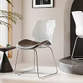 Modern Transparent Dining Chairs With Metal Legs And Small Round Table In Minimalist Interior