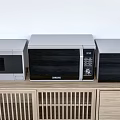 Modern Kitchen Appliances Including Microwave And Oven On Wooden Countertop