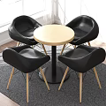 Modern Round Dining Table With Black Chairs And Wooden Legs On Gray Rug