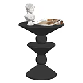 Black Spiral Base Side Table With White Statue And Open Magazine
