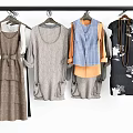 Clothes Hangers With Various Dresses Tops Vests And Skirts Hanging On Rail