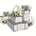 Modern Floral Display With Stacked White Cube Boxes Pink Roses Yellow Flowers And Greenery